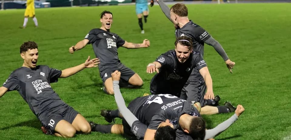 Players celebrating a goal during football match