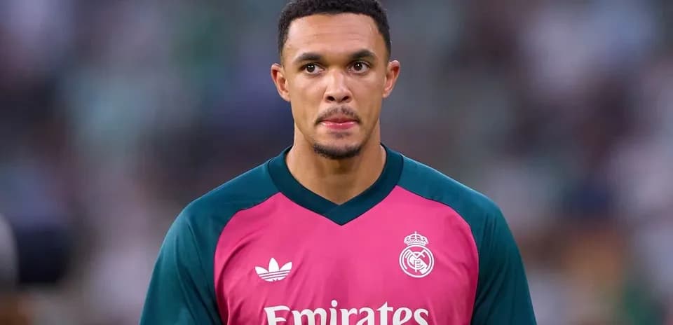 Goalkeeper in pink jersey during match warm-up