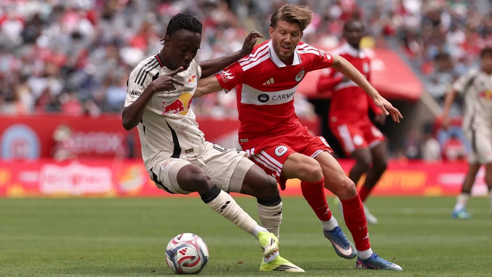 New York Red Bulls player tackles Chicago Fire opponent