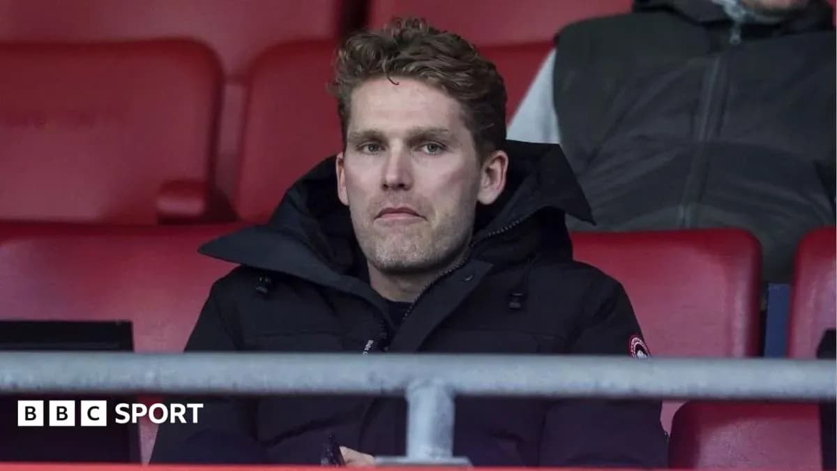 Man sitting in stadium stands during match