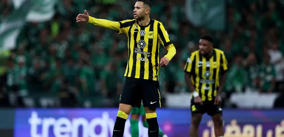 Player gesturing during a match with fans in background