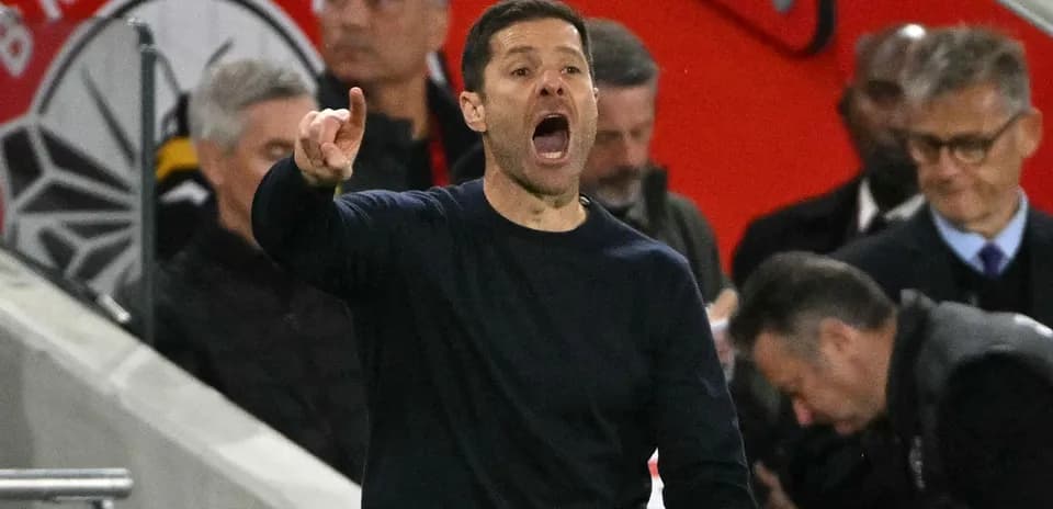 Manager gesturing and shouting on the sidelines