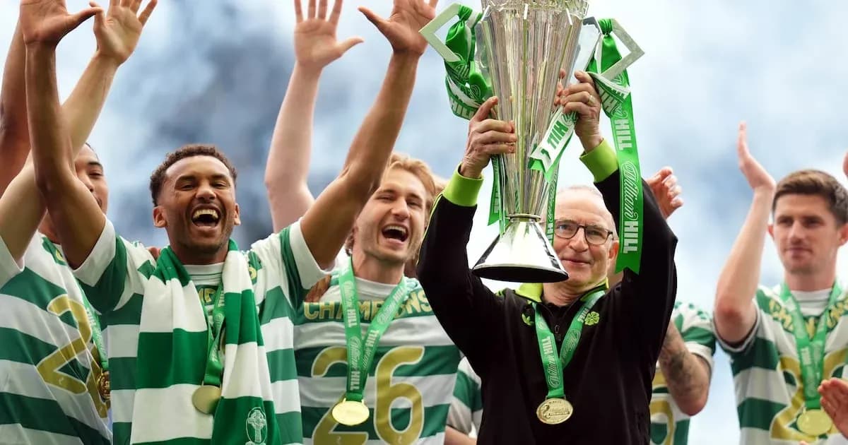 Celtic players celebrating with trophy on stage