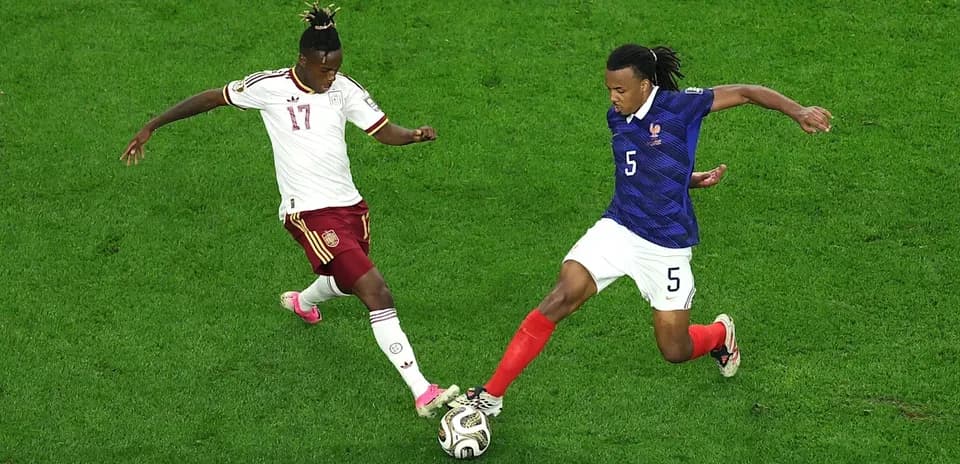 Two players contesting the ball during a match
