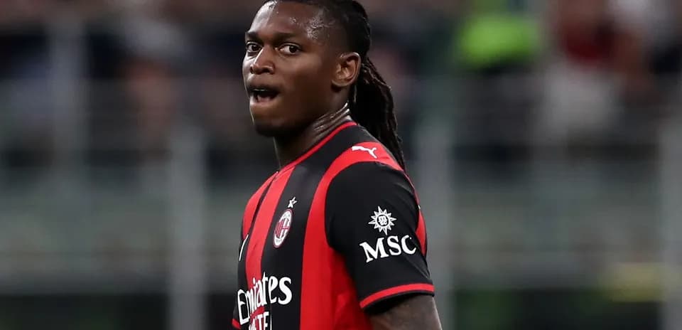 Player in AC Milan jersey during match action