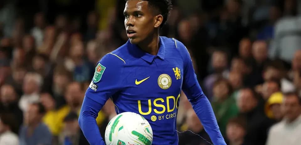Player in blue Chelsea kit holding a ball