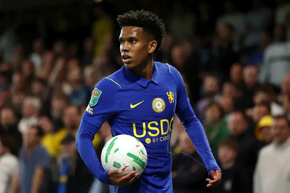Player in blue Chelsea kit holding a ball