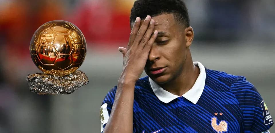 Player holding head with Ballon d'Or nearby