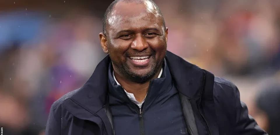Smiling coach on the sidelines during a match