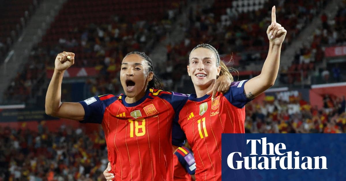 Two Spain players celebrating a goal together