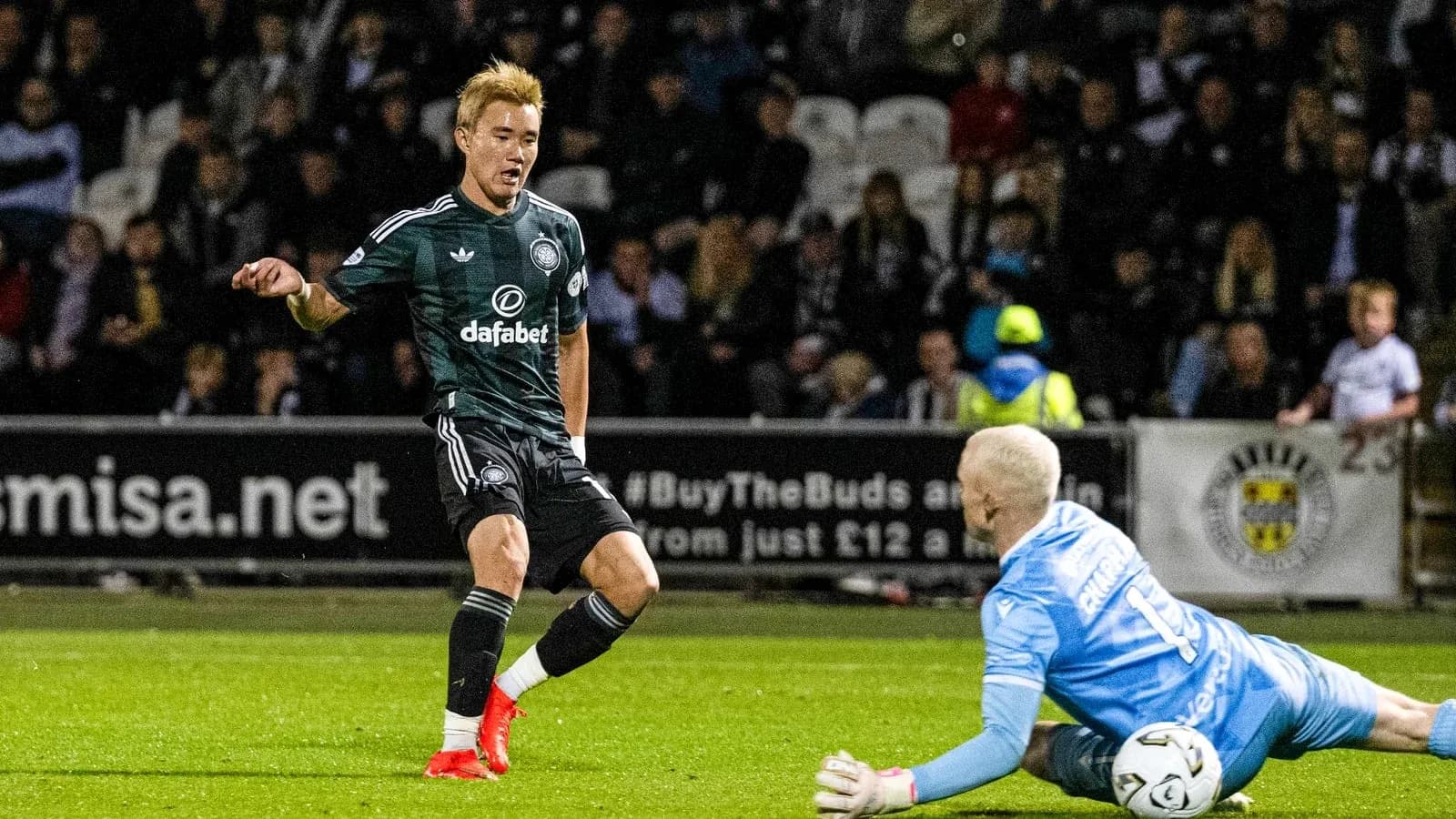 Player attempting to score as goalkeeper dives