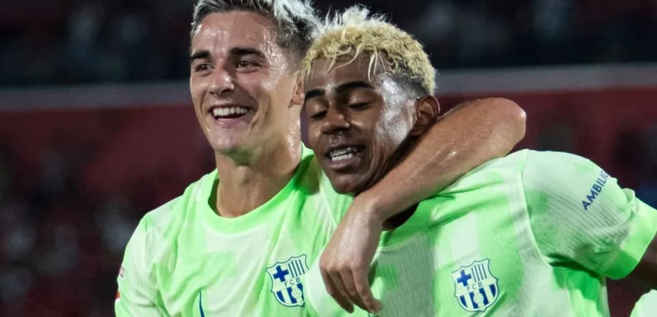 Two players celebrating a goal on the field