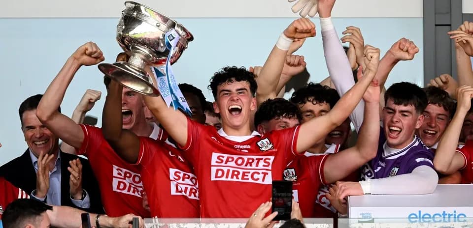 Team celebrating victory with trophy in hand