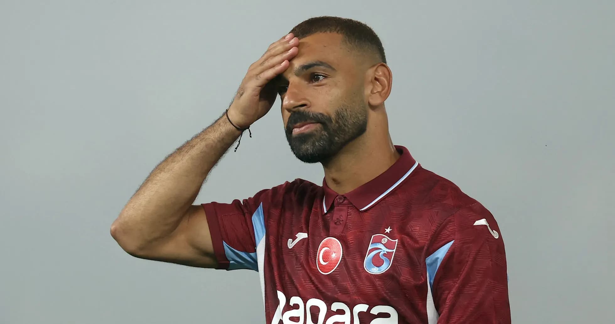 Player touching his forehead in club jersey