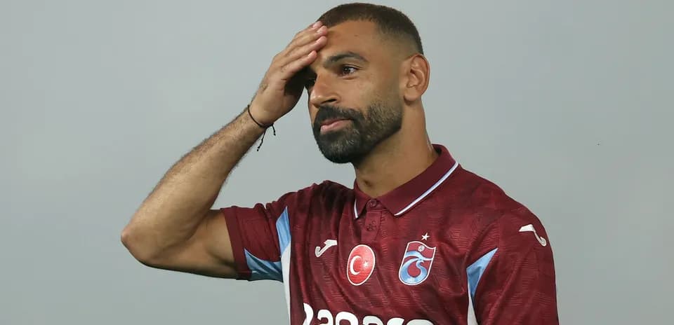 Player touching his forehead in club jersey