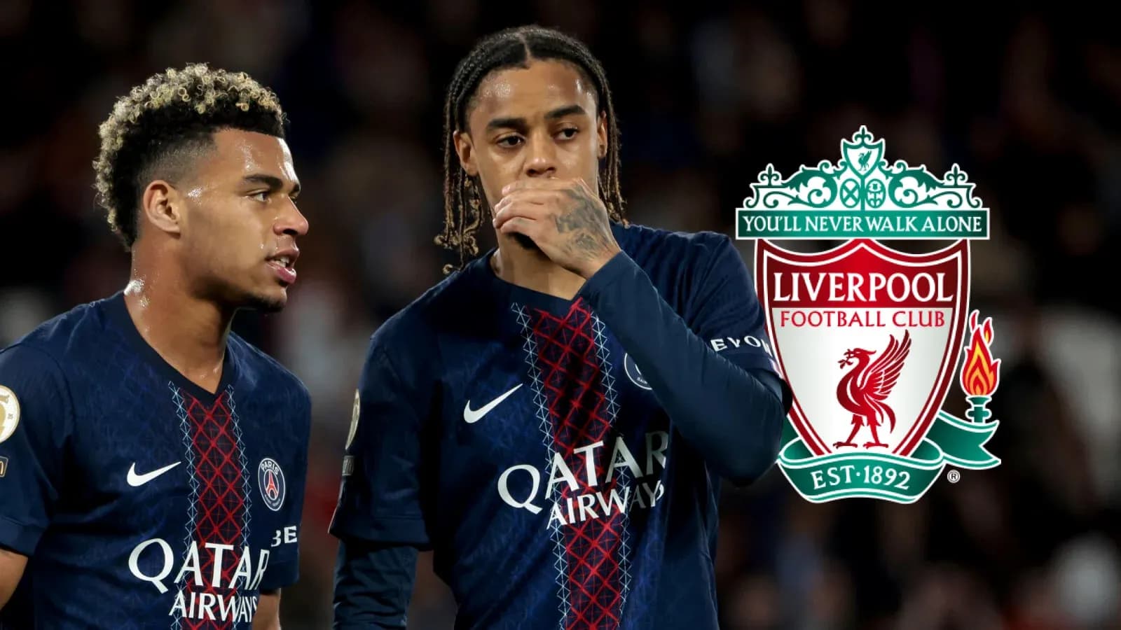 Two players discussing during a match, Liverpool logo