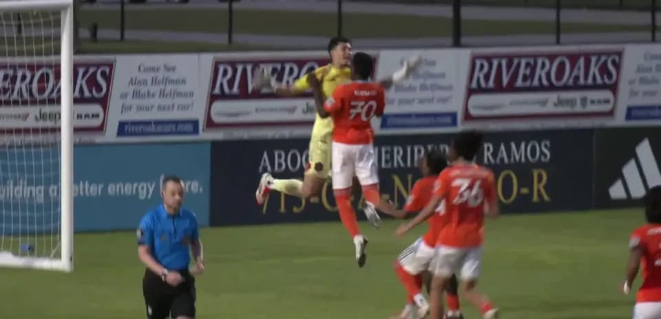 Goalkeeper catching the ball during match