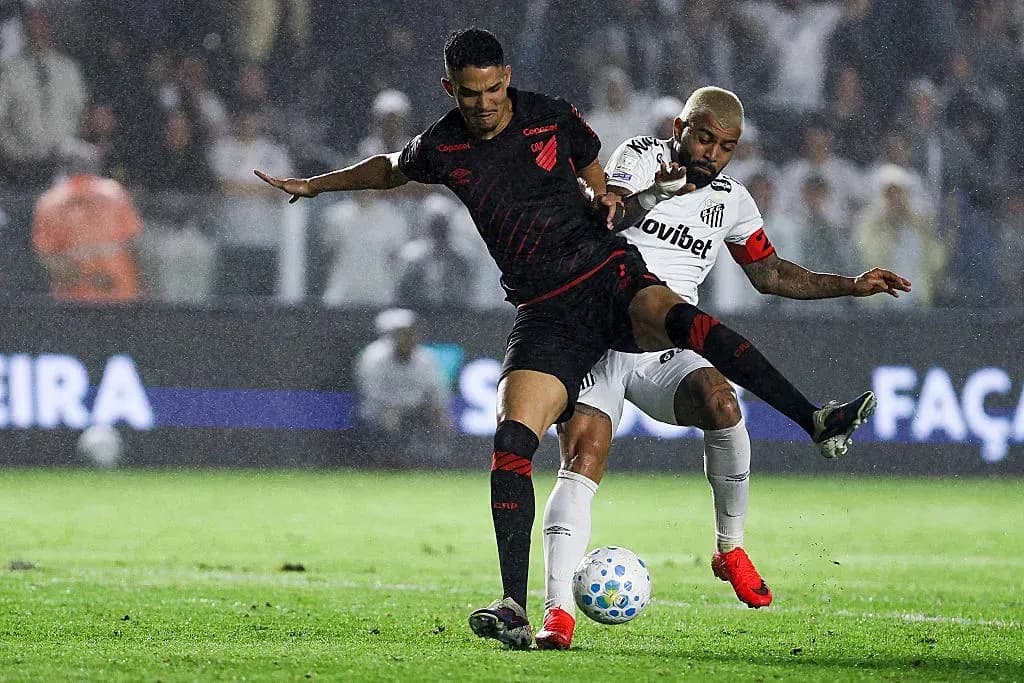 Two players battling for the ball during rain
