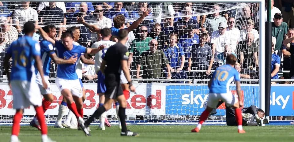 Players reacting near goal during football match