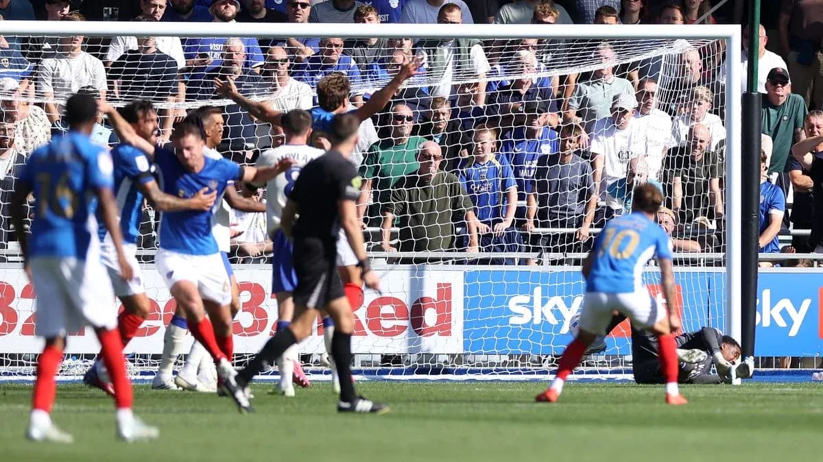 Players reacting near goal during football match
