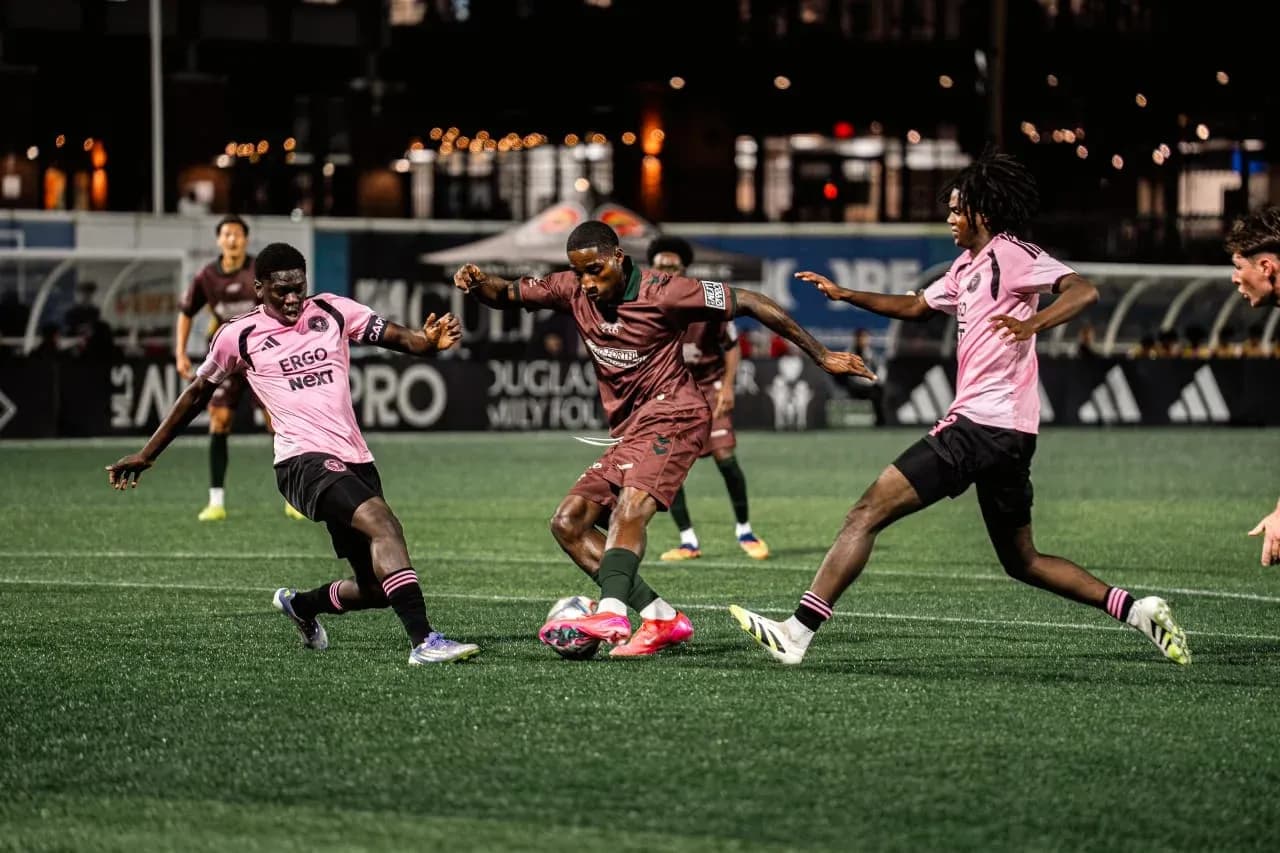 Players competing for the ball in MLS Next Pro