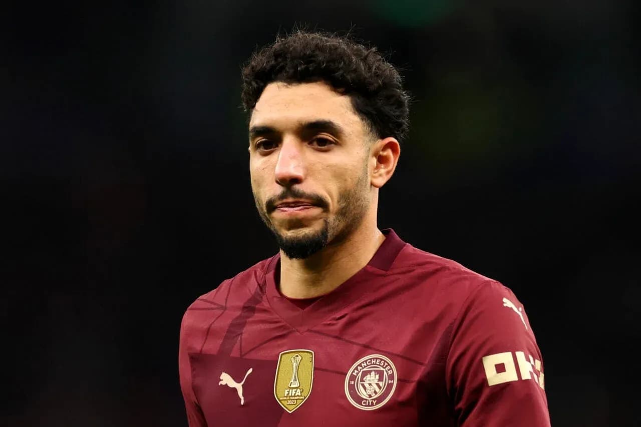 Player wearing maroon Manchester City jersey during match