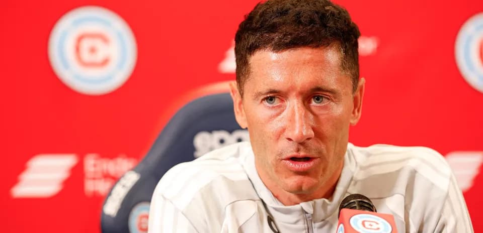 Player speaking at press conference with microphone