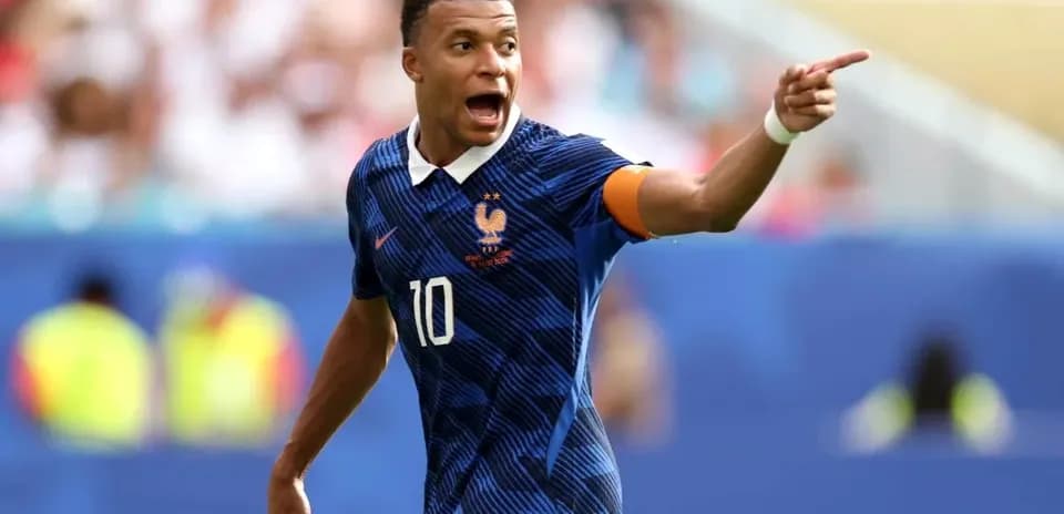 Kylian Mbappé directing teammates during a match