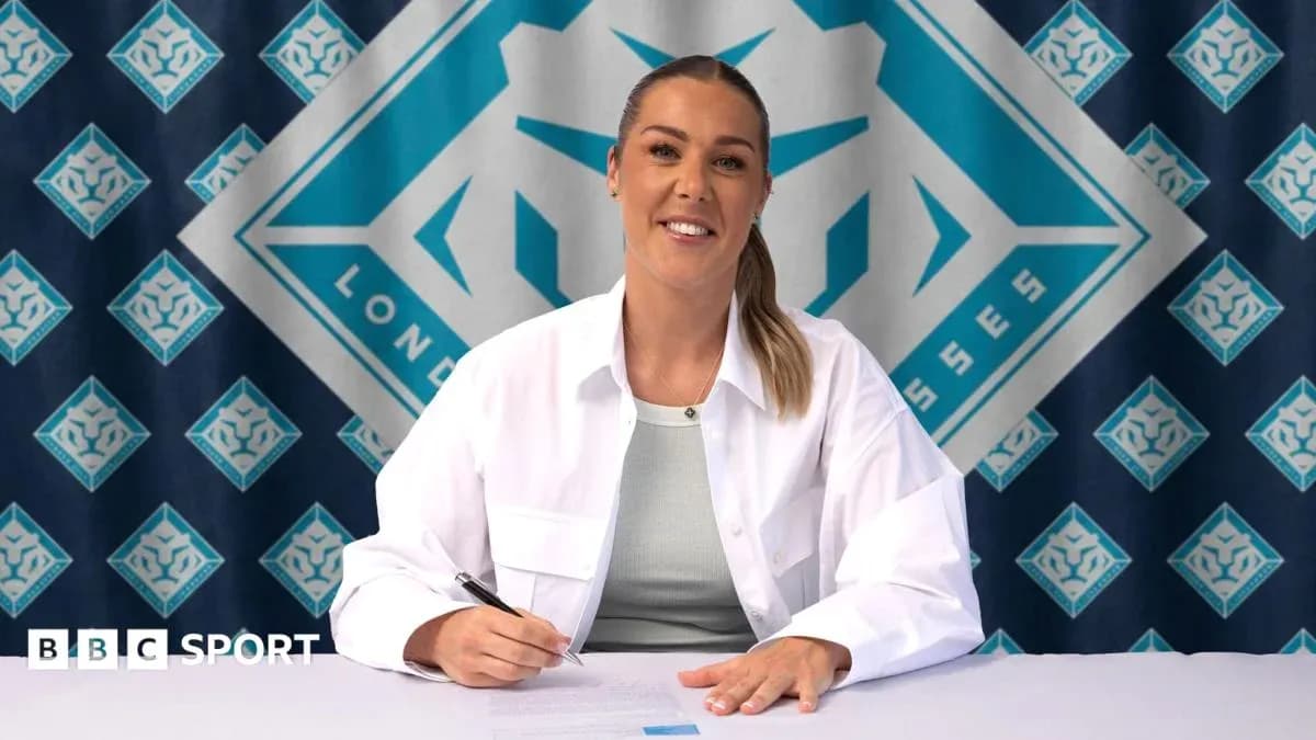 Player signing contract at press conference table