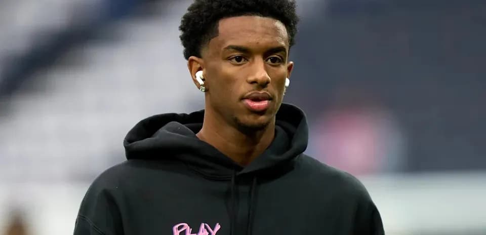 Athlete wearing earbuds and hoodie before game