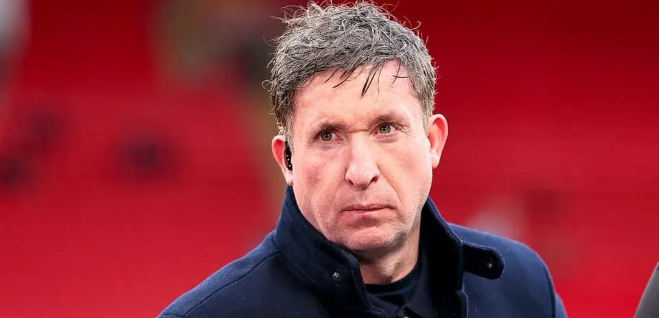 Man in coat with earpiece at stadium