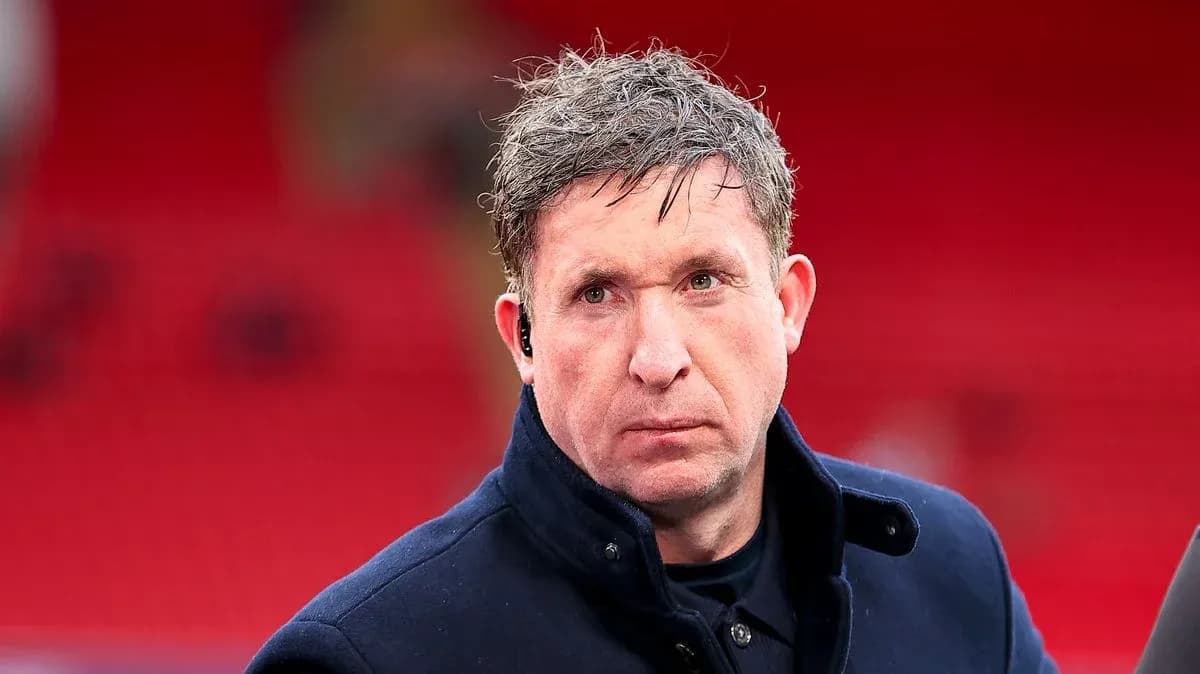 Man in coat with earpiece at stadium