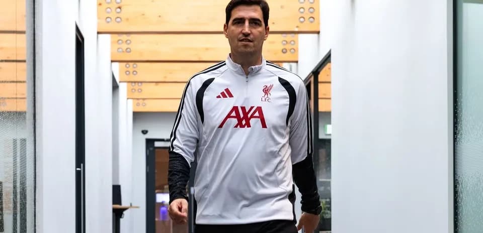 Coach walking through training facility hallway