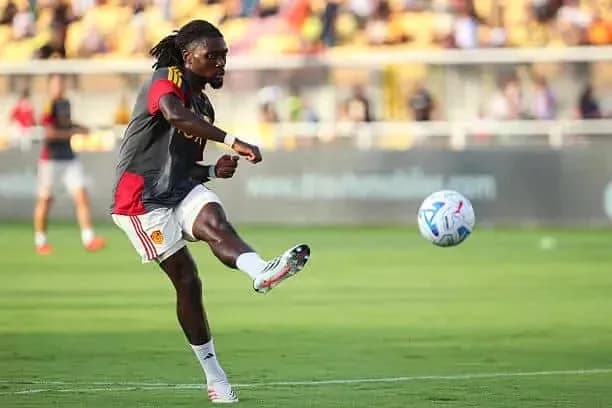 Player striking a soccer ball during warm-up