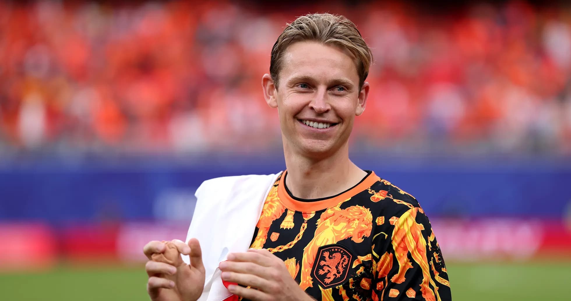 Player smiling in vibrant team-themed warm-up shirt