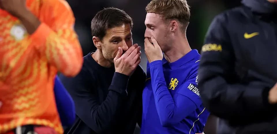 Coach speaking to player after the match