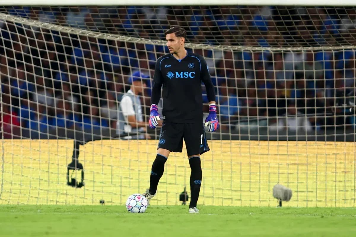 Goalkeeper in black uniform standing near goalpost