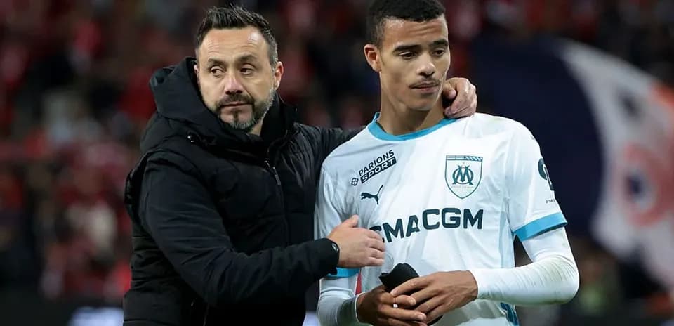 Coach comforting player after match at stadium