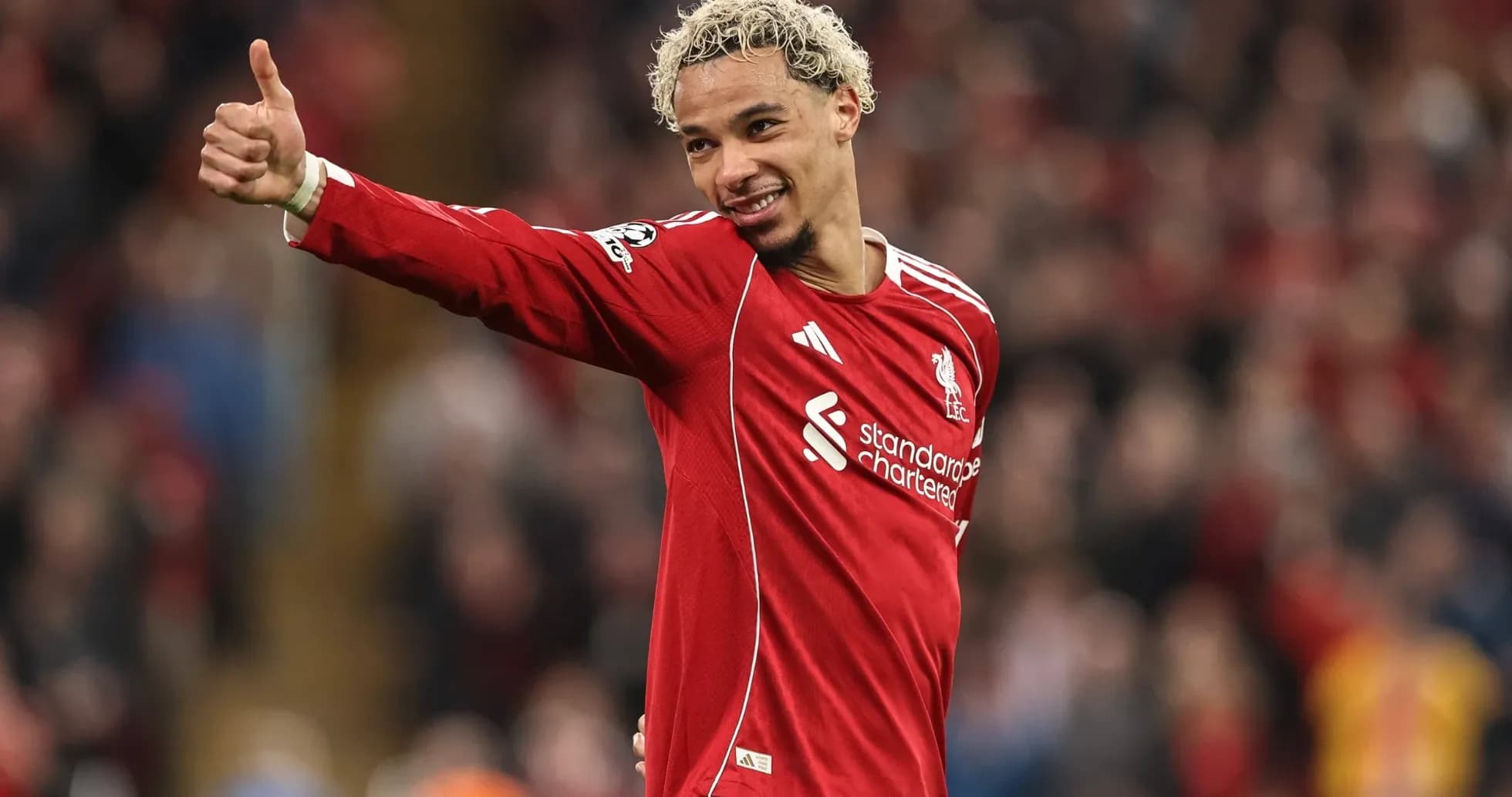 Player celebrating and giving thumbs up on field