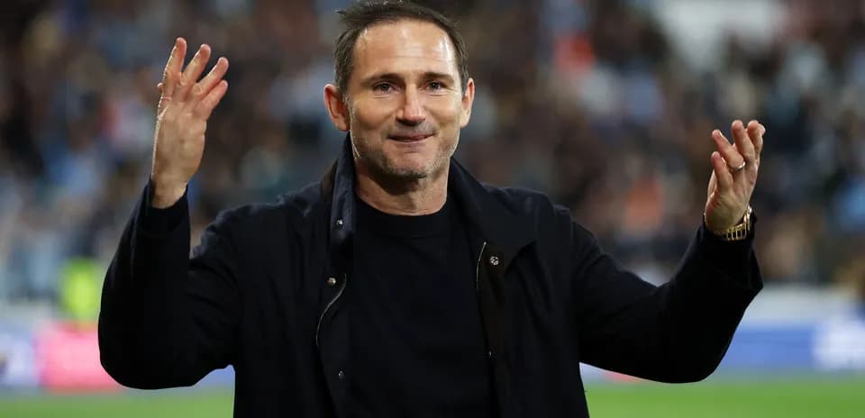 Coach gesturing to fans during match celebration