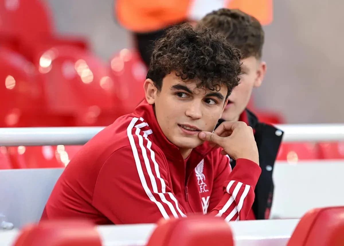 Player in Liverpool kit sitting on bench