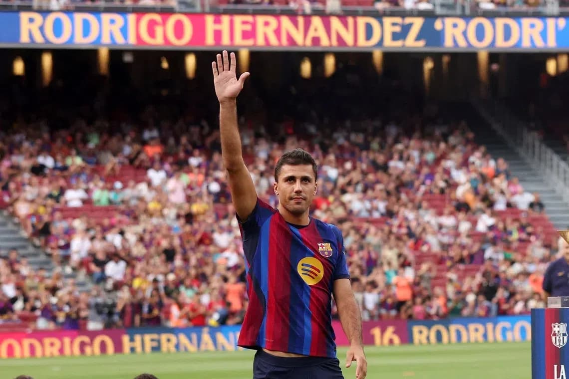Player waving to fans at stadium event