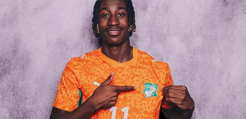 Player pointing at Ivory Coast national team logo