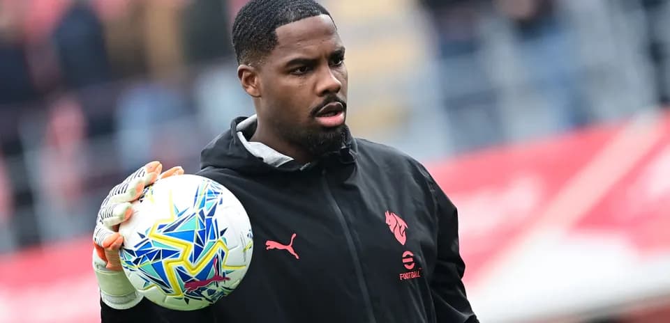 Goalkeeper holding a soccer ball during warm-up