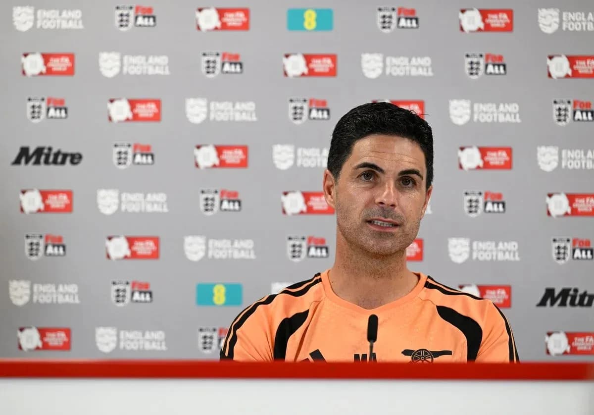 Manager speaking at press conference with backdrop