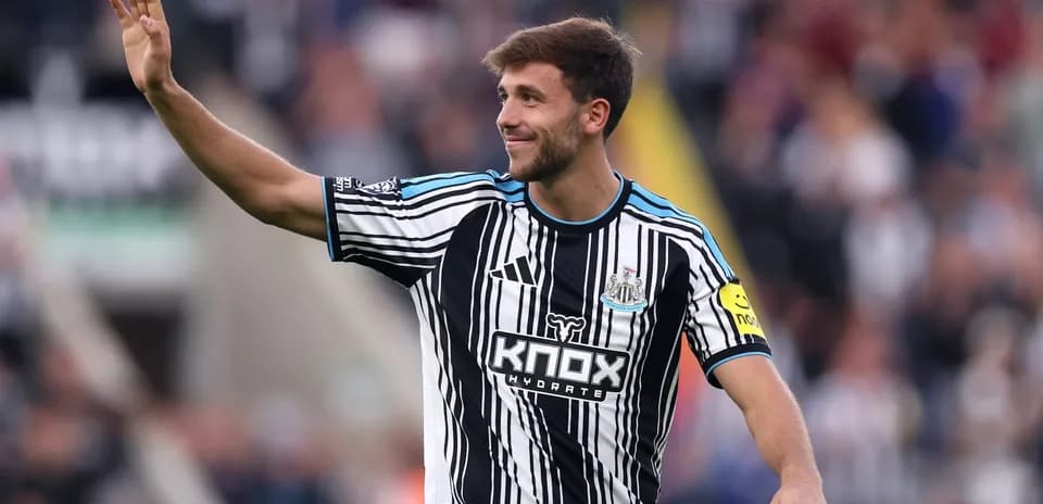 Player waving to fans during match at St James' Park