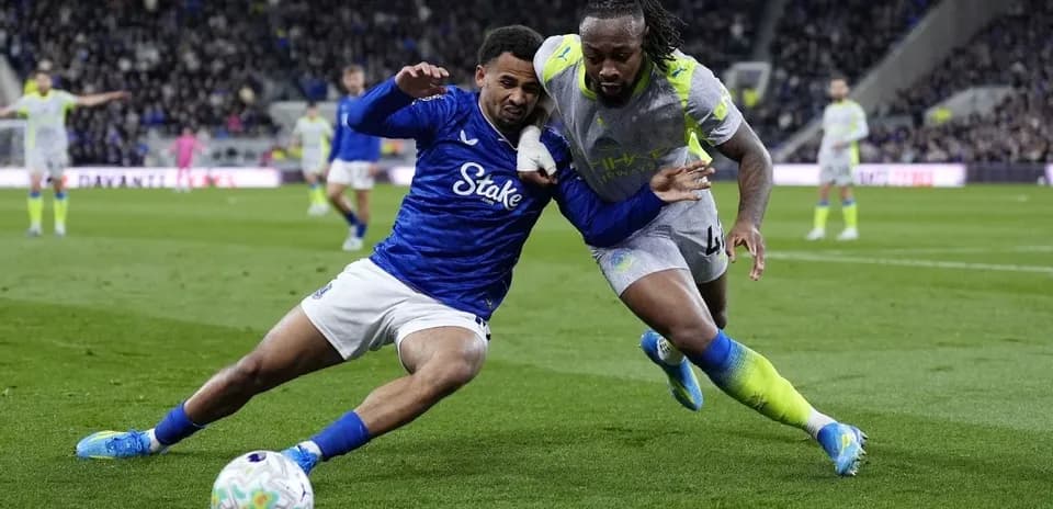 Two players battling for the ball on the field