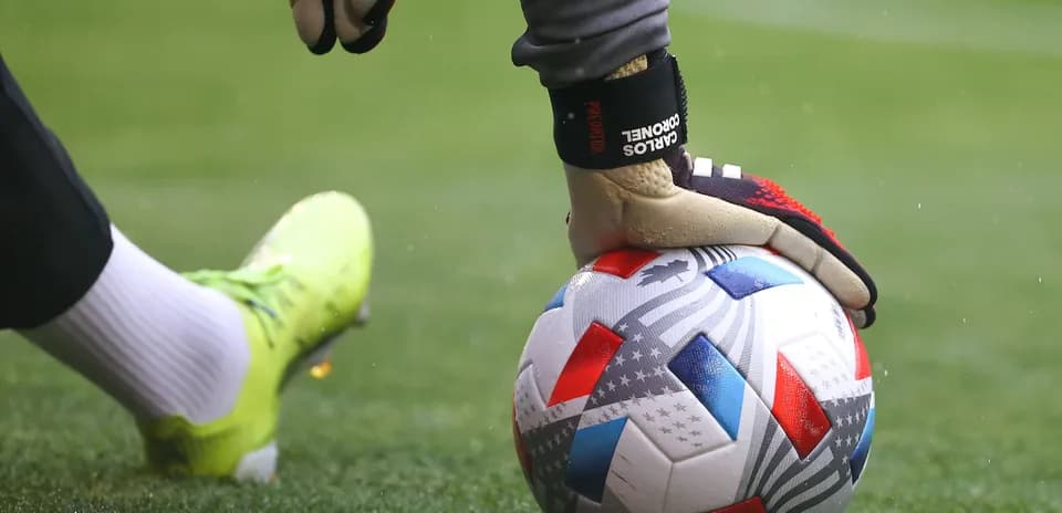 Goalkeeper preparing to kick a soccer ball