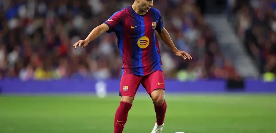 Player dribbling a ball on the pitch