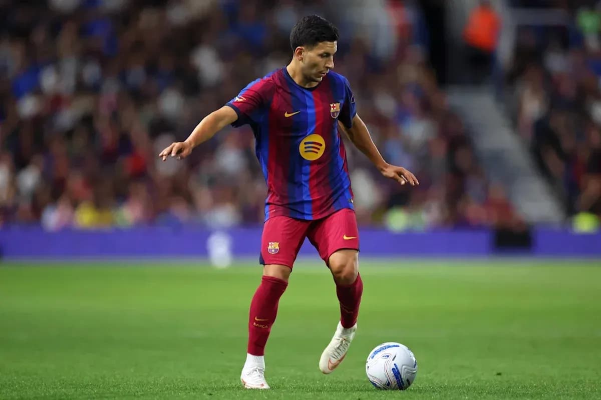 Player dribbling a ball on the pitch